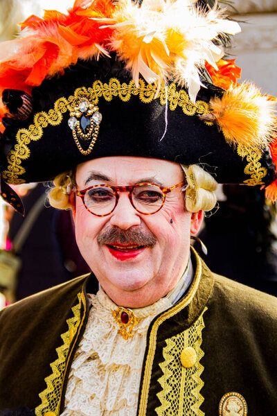 VENICE, ITALY - FEBRUARY 9, 2013: Unidentified man with Venetian carnival mask in Venice, Italy. At 2013 it is held from January 26th to February 12th.