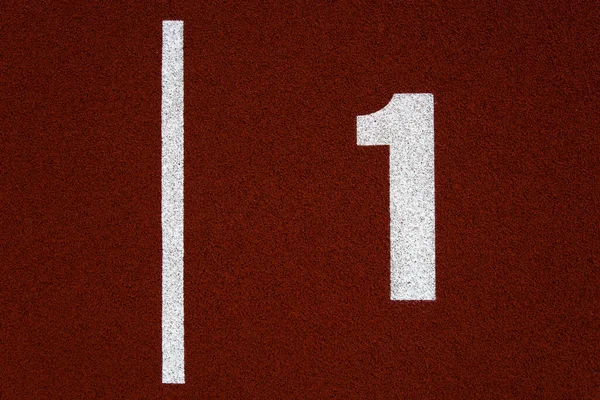 Closeup of the number one on red stadium running track