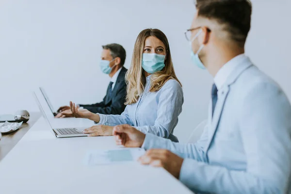 Group of business people have a meeting and working in the office and wear masks as protection from corona virus