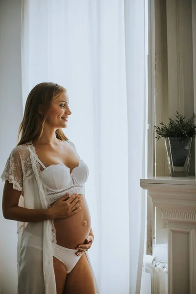 Ganska Ung Gravid Kvinna Står Vid Fönstret Rummet Dagsljus — Stockfoto