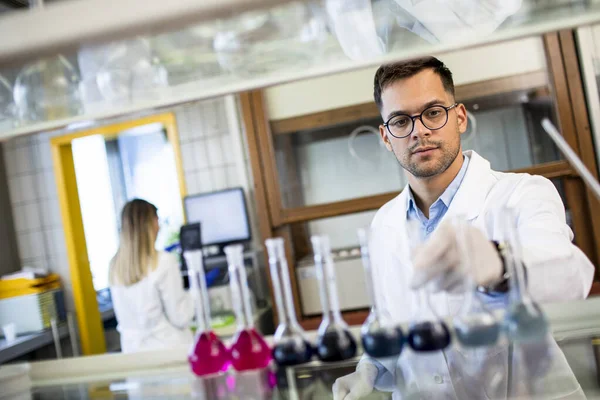 Jonge Onderzoeker Controleert Reageerbuizen Het Laboratorium — Stockfoto