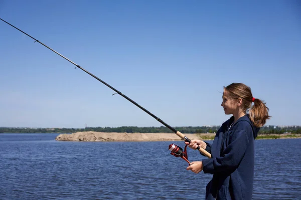 Little girl with a fishing rod