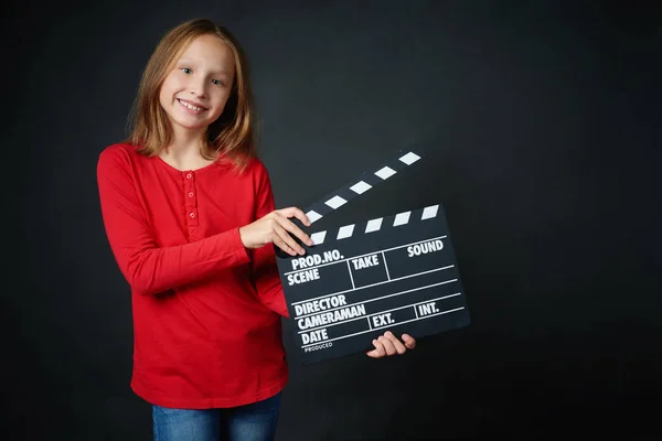 Portrait of Happy smiling girl holding clap board — Stock Photo, Image