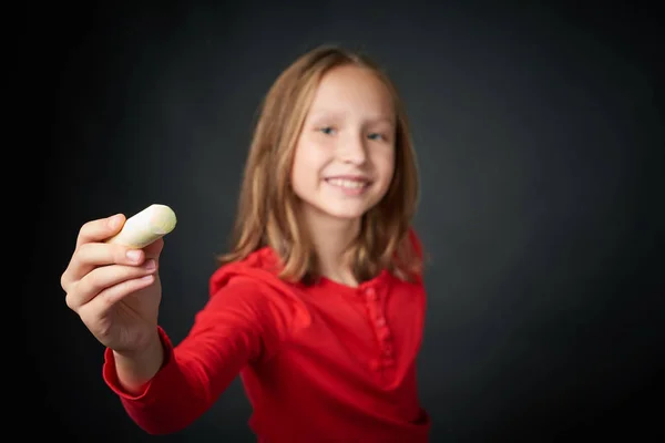 Girl holding a chalk pointing at blank copy space for your text — Stock Photo, Image
