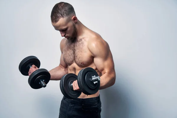 Strong sport sirtless man making weightlifting with dumbbells — Stock Photo, Image