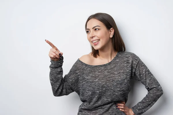 Happy playful brunette woman looking at copy space — Stock Photo, Image