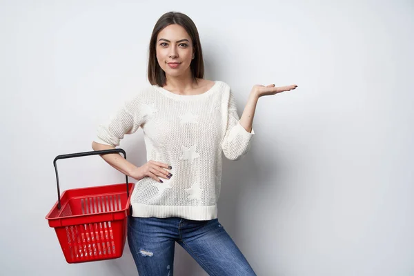 Woman holding showing empty shopping basket pointing — Stock Photo, Image