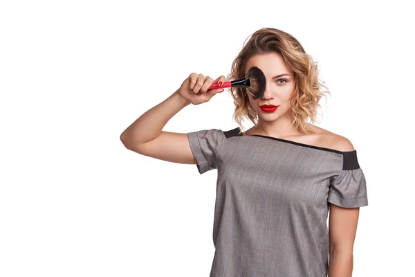 Fashionable woman stylist standing posing with makeup brush — Stock Photo, Image