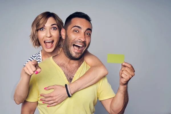 Casal feliz no estúdio rindo sobre cinza — Fotografia de Stock