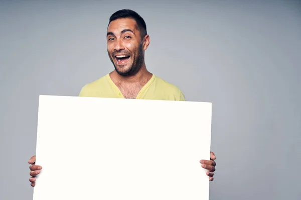 Happy laughing hispanic man holding blank white board — Stock Photo, Image