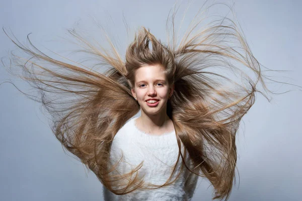 Teen girl with long hair flying in air — Stock Photo, Image