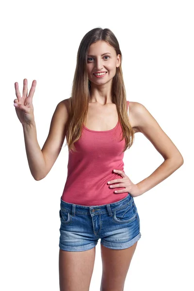 Mujer feliz en pantalones cortos mostrando tres dedos — Foto de Stock