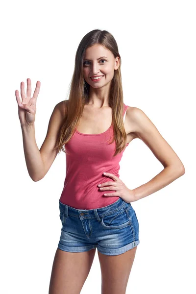 Mulher feliz em shorts mostrando quatro dedos — Fotografia de Stock