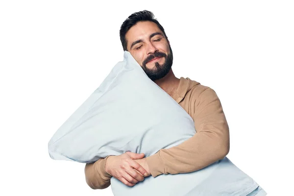 Homem em casa roupas abraçando travesseiro — Fotografia de Stock