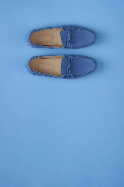 Blue suede man's mocassin shoes over blue background — Stock Photo, Image