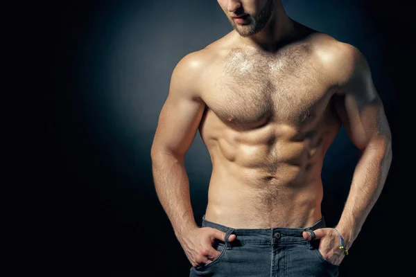 Cropped image of muscular shirtless with hands in pockets — Stock Photo, Image