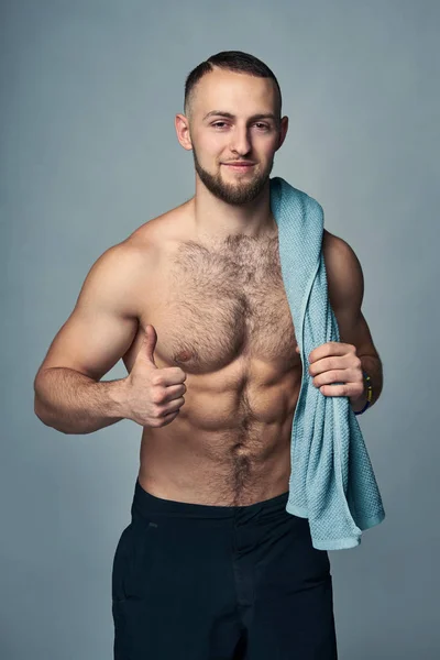 Muscular shirtless man with towel over shoulder — Stock Image Muscular shirtless man with towel over shoulder Royalty Free Stock Images