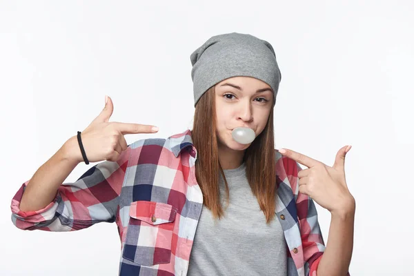 Closeup of cheeky teen girl blowing bubblegum and pointing at it — Stock Photo, Image