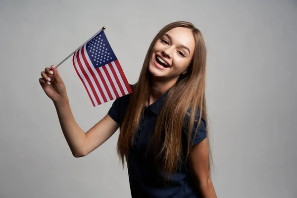 Happy female holding USA flag — Stock Photo, Image