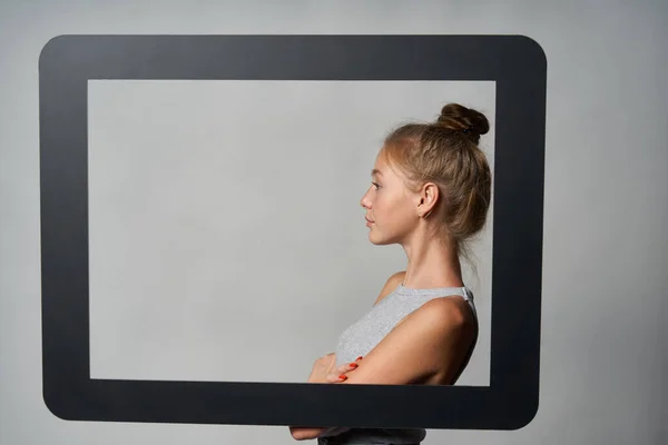 A következő profilja: girl standing behind digital tablet frame and looking forward at blank copy space — Stock Fotó