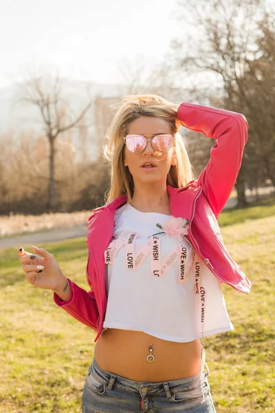 Vacker Blond Kvinna Poserar Snygg Rosa Skinnjacka Utomhus — Stockfoto