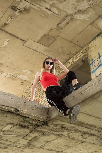 Sporty chic woman posing at abandoned construction site