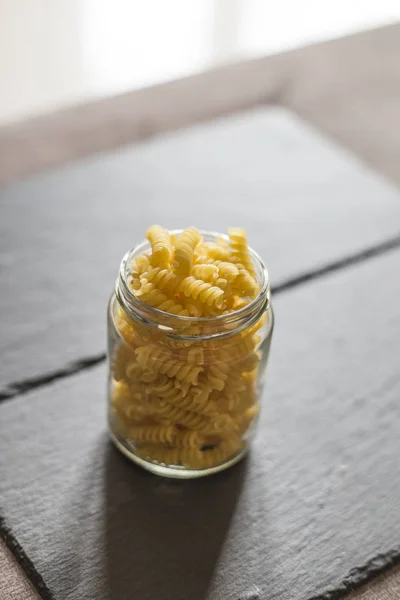 close up raw pasta in a jar