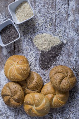 Ekmek ve taze ekmek buns ahşap bir masa üzerinde bir sepet içinde bir sürü