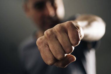 closeup of a young caucasian man throwing a punch to the observer, with a dramatic effect clipart