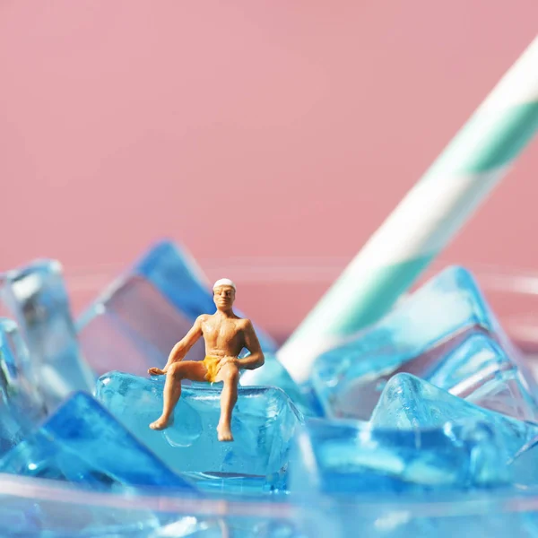 Miniature Man Wearing Swimsuit Swim Cap Relaxing Ice Cubes Blue — Stock Photo, Image