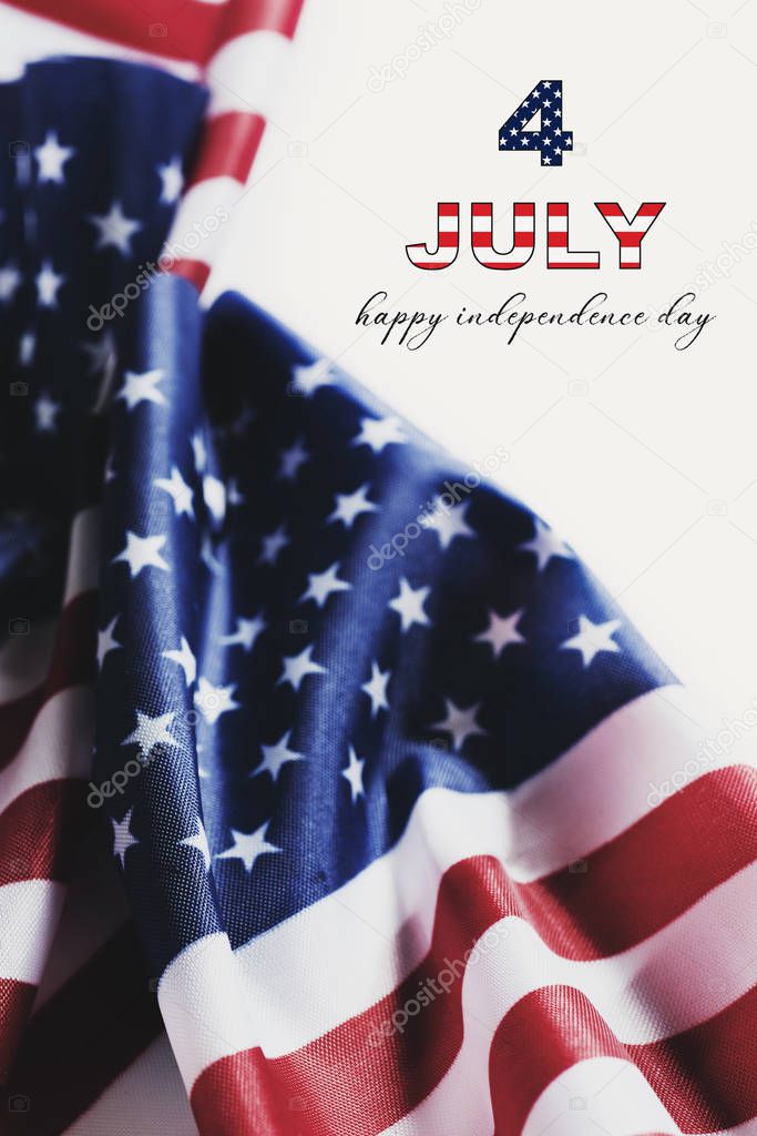 some american flags and the text 4 of july, happy independence day against an off-white background