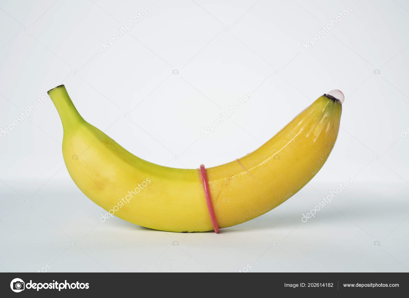 Closeup Banana Pink Condom White Background Stock Photo by