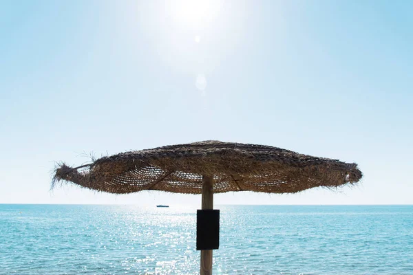 Close Rustic Umbrella Made Natural Fibers Beach Front Ocean Sunbeam — стоковое фото