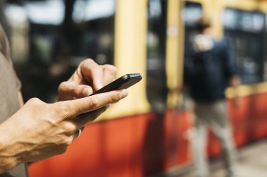 Metro bir tren ve tramvay istasyonu bir akıllı telefon kullanan genç bir beyaz adam closeup