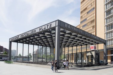 BERLIN, GERMANY - MAY 24, 2018: Entrance to the Bahnhof Potsdamer Platz station, at Potsdamer Platz, an important square in the center of the city, with many buildings built after the fall of the Wall clipart