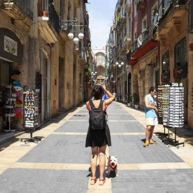 Tarragona, İspanya - 28 Temmuz 2018: bir turist kısmı Alta, eski kasaba Tarragona, İspanya, arka planda Katedrali ile Carrer büyük street, bir resim çekmek