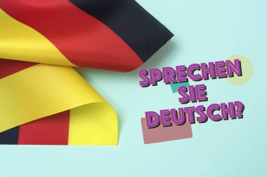 Bazı bayraklar Almanya ve soru bilmez sie deutsch? Almanca biliyor? Almanca, yeşil bir arka plan üzerine yazılmış