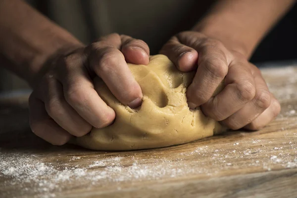 Closeup Young Caucasian Man Kneading Piece Dough Wooden Table — Stock Photo, Image