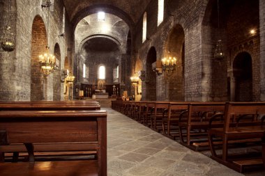 RIPOLL, SPAIN - DECEMBER 28, 2017: A view of the interior of the church of the historical Monastery of Santa Maria de Ripoll, an important landmark in Catalonia clipart