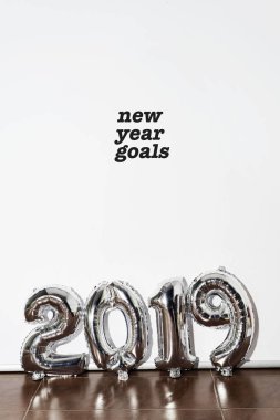 metin yeni yıl hedefleri ve beyaz bir arka plan karşı numarası 2019 oluşturan gümüş bazı sayı şeklindeki balonları
