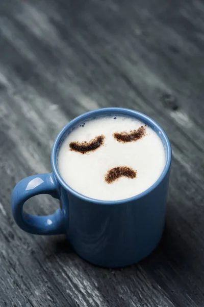 Closeup Blue Cup Cappuccino Sad Face Drawn Cocoa Powder Its — Stock Photo, Image