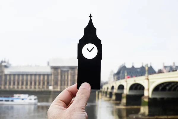 Close Seup Hand Holding Paper Cutout Shape Clock Tower Palace — стоковое фото