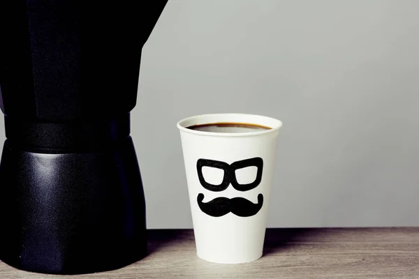 Tasse Kaffee mit einem Mann Gesicht darin gezeichnet — Stockfoto