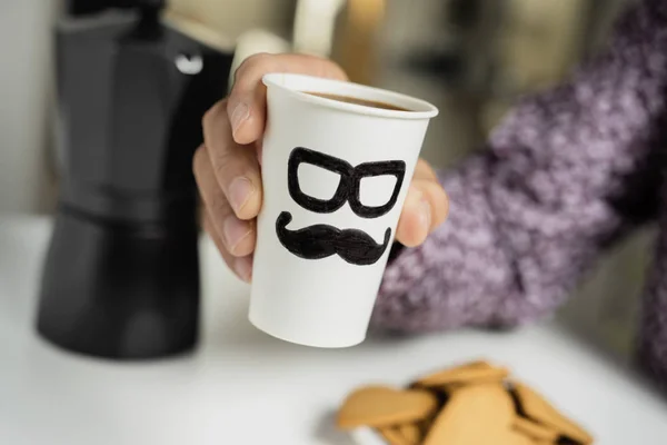 Man with cup of coffee with a man face — Stock Photo, Image