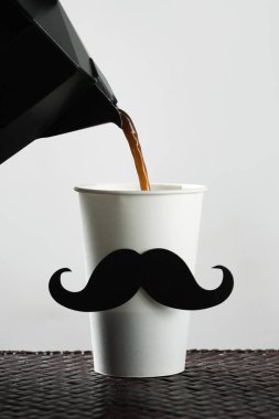 cup with a moustache being filled with coffee clipart