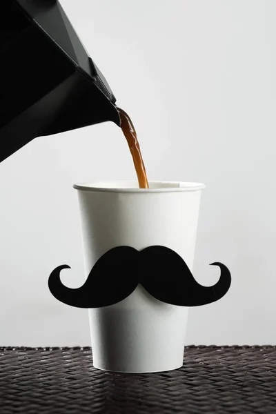 Cup with a moustache being filled with coffee — Stock Photo, Image