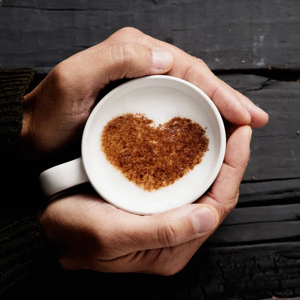 Homme avec une tasse de cappuccino avec un cœur — Photo