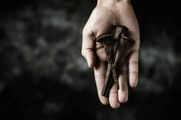 rusty nails on the hand of a man