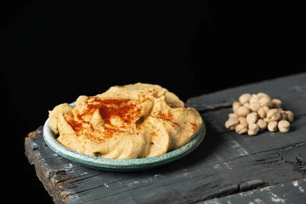 Piatto con hummus fatto in casa su un tavolo — Foto Stock