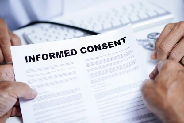 Senior man reading an informed consent — Stock Photo, Image